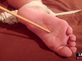 BDSM whipped Asian lez suffers feet flogging lesson